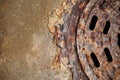 Rusty manhole cover with beautiful colours and textures