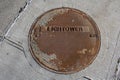 Rusty manhole cover on New York City sidewalk, USA Royalty Free Stock Photo