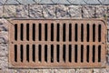 Rusty manhole rectangular grating of the drainage system. Royalty Free Stock Photo