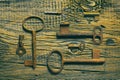 Rusty medieval keys on worn out wood table Royalty Free Stock Photo