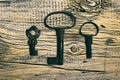 Rusty medieval keys on worn out wood table