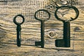 Rusty medieval keys on worn out wood table Royalty Free Stock Photo