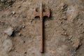 Rusty medieval-style pitchfork on dirt ground Royalty Free Stock Photo