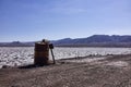 Rusty Metal Barrel and Wooden Sing in the Atacama Desert Royalty Free Stock Photo