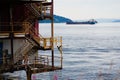 Rusty metal building with stairs on the fjord with a boat surrounded by hills in Trondheim, Norway Royalty Free Stock Photo