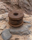 Rusty metal cable spool on rocks Royalty Free Stock Photo