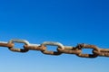 Rusty metal chain on a blue background Royalty Free Stock Photo