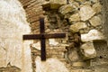 Rusty Metal Cross on a rustic stone wall Royalty Free Stock Photo