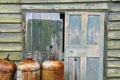 Rusty metal cylinders and weathered shed door