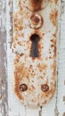 Rusty metal distressed texture of old door handle with keyhole Royalty Free Stock Photo