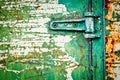 Rusty metal door with hinge cracked paint