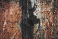 Rusty metal door with lock texture background. Old worn iron plate with peeled off paint and scratches Royalty Free Stock Photo