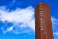 Rusty metal fragment of the Berlin Wall Berliner Mauer in the background of blue sky