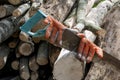 A rusty metal hacksaw with old working gloves saws a wooden log Royalty Free Stock Photo