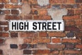 Rusty Metal High Street Road Sign On Brick Wall