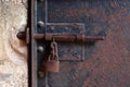 Rusty metal latch with padlock