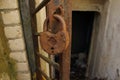 Aged rusty metal lock hanging on metal bar door to abandoned bomb shelter Royalty Free Stock Photo