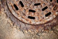 Rusty manhole cover with beautiful colours and textures.