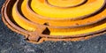 Rusty metal manhole cover Royalty Free Stock Photo