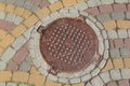 Rusty metal manhole cover in a street Royalty Free Stock Photo