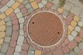 Rusty metal manhole cover in a street Royalty Free Stock Photo