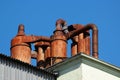 Rusty metal pipes and chimneys on a roof Royalty Free Stock Photo