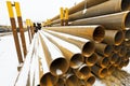 Rusty metal pipes in stacks on outdoor warehouse Royalty Free Stock Photo