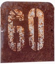 Rusty metal plate with the number sixty