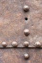 Rusty metal plate with a seam and rivets Royalty Free Stock Photo