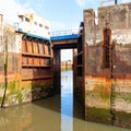 Rusty Metal River Lock Gate with Concrete Walls Under a Cloudy Blue Sky during Daytime Royalty Free Stock Photo