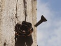 Rusty metal rose flower and nail on a wooden pole Royalty Free Stock Photo