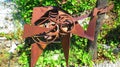 Rusty metal sculpture of headless guitar player