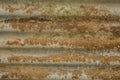 A rusty metal sheet. deep rust on metal. yellow-brown rust on a gray metallic surface. horizontal lines. Royalty Free Stock Photo