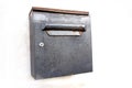 Rusty metal square mail box on white wall background