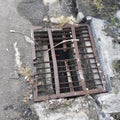 a rusty metal storm drain grate Royalty Free Stock Photo