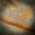 Rusty metal surface with a textured pattern of reddish-orange corrosion across a Royalty Free Stock Photo