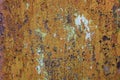 Rusty metal texture background. Old worn iron door with peeled off orange paint Royalty Free Stock Photo