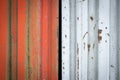 Rusty metal texture background. Red and white corrugated steel sheets with scratches and corrosion stains. Old worn iron garage Royalty Free Stock Photo
