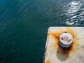 A rusty mooring bolard in two colours Royalty Free Stock Photo