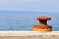 Rusty mooring bollard on port of Podgora