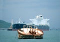 Rusty mooring buoy. Tanker in the background