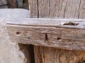 Rusty nail in wood. Bent rusty nail in a board from a wooden fence. Old wood texture. Barn bolt