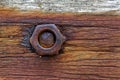 Rusty nut and bolt on wood Royalty Free Stock Photo