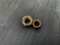 rusty nuts unused on a gray background in the barn Royalty Free Stock Photo