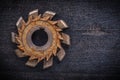 Rusty obsolete cutting tool on wooden board