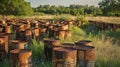 Rusty oil barrels in a field symbolizing crude oil extraction and resource dependency Royalty Free Stock Photo