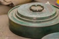 Rusty old anti-tank mine or AT mine, a type of land mine designed to damage or destroy vehicles including tanks and armored fight