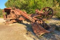 A rusty old backhoe, or excavator, left out in nature