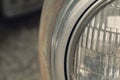 A rusty old car front headlight close up with copy space Royalty Free Stock Photo