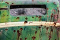 Rusty old car metal with bullet holes. Royalty Free Stock Photo